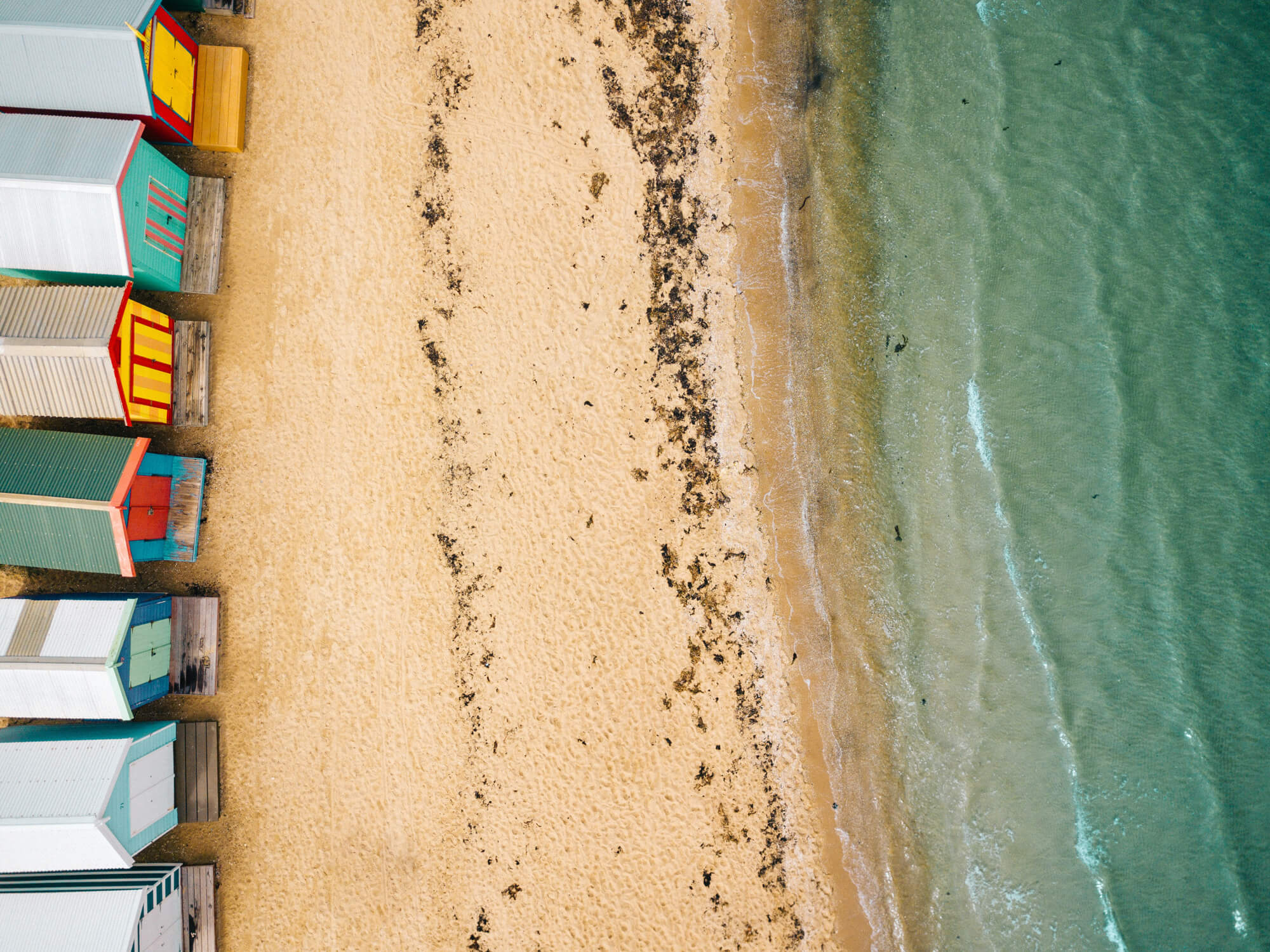 Looking down on Brighton Beach and colourful bathing boxes from above