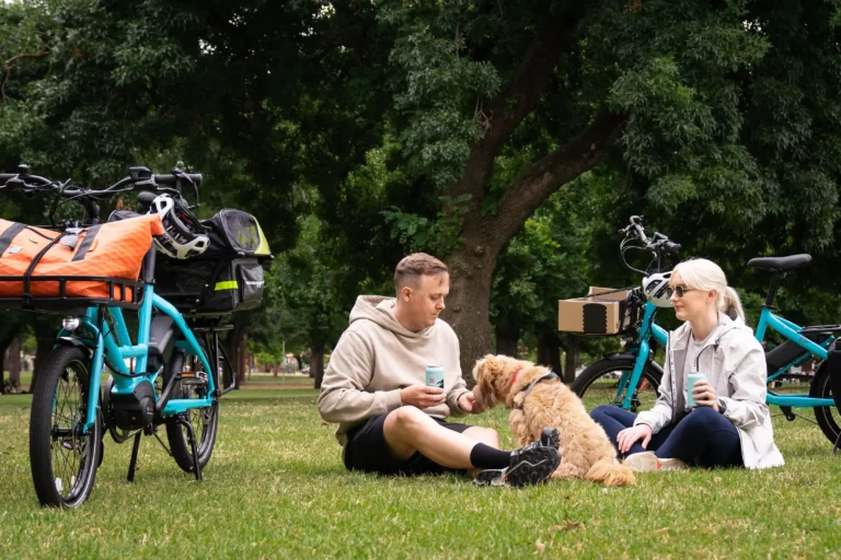 Kim, Nick and their dog Peggy enjoying a fun ride in the park on their Lug+Carrie ebikes. Their Turn Quick Hauls are perfect for grabbing groceries or taking their dog on a mini adventure.